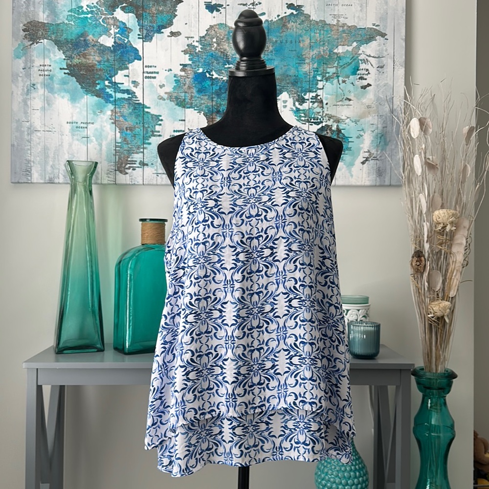 Flowy white shirt with no sleeves and blue pattern,double layered. Zac & Rachel.
